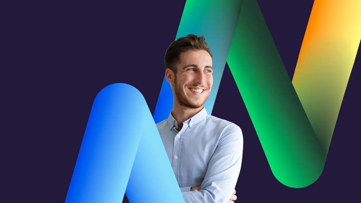 Portrait of a smiling young man in a light blue button-down shirt standing against a dark backdrop, surrounded by smooth, thick 3D graphic ribbons flowing in blue, green, and yellow.
