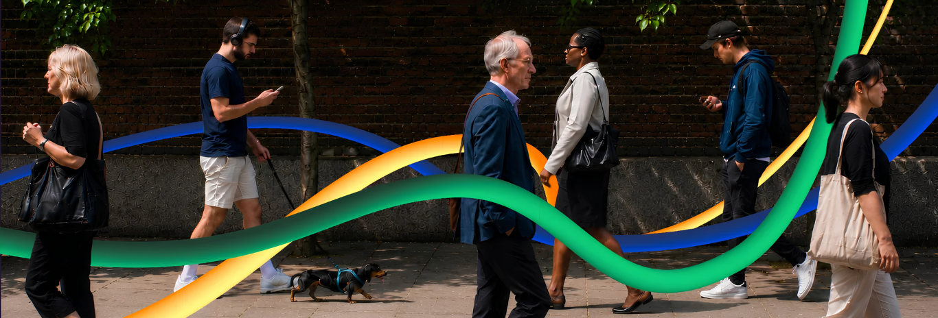 Diverse pedestrians walking along a city pavement past a dark brick wall, overlaid with flowing 3D ribbon illustrations in vibrant green, yellow, and blue.